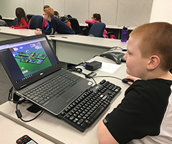male student playing a computer game