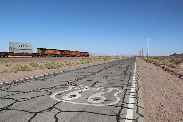 photos of US Route 66 with train and rail road in the background
