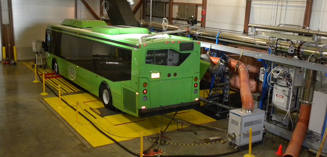 green bus in test garage