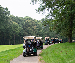 golf carts driving along path on course