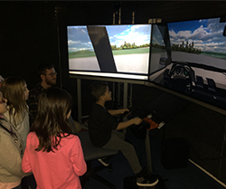students take turns driving virtual reality driving simulator