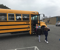 students walking off school bus